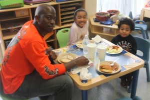 Gunnery Sgt. Charles Maddox eats with his children Maya and Taiki Maddox during the Month of the Military Child Picnic at the   Child Developement Center at Marine Corps Air Station Beaufort.  (Photo by Pfc. Brendan I. Roethel)