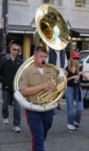 Corporal Dalton Lee, a tuba player with the 1st Marine Division Band, from Camp Pendleton, Calif., plays his tuba as he crosses a street during the band’s performance in downtown San Francisco.  (Photo by Sgt. Joseph Scanlan)