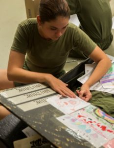 A recruit personalizes her foot locker during free time. Recruits can decorate the inside of their foot lockers with photos and letters to keep them motivated during training. Free time, which is restricted to inside the barracks, is an hour where recruits are given the opportunity to read and write letters, unwind and prepare themselves and their equipment for the next day. (Photo by Lance Cpl. Vaniah Temple)