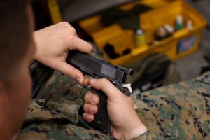 U.S. Marine Corps Sgt. Tyler Neel, the platoon sergeant of the Parris Island armory, performing a weapons check. (U.S. Marine Corps photo by Lance Cpl. Ryan Hageali)