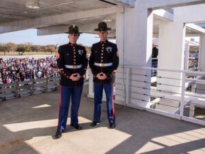Staff Sgt. Christopher Davis and Staff Sgt. Mark Gulotta, pose for a photo on the Peatross Parade aboard Marine Corps Recruit Depot Parris Island. Davis spent weeks training Gulotta to take over the position of "the voice". (U.S. Marine Corps photo by Lance Cpl. Michelle Brudnicki)