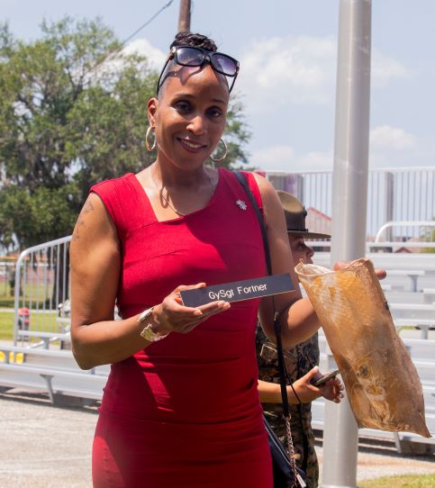 Sgt. Maj. Robin C. Fortner (Ret.) holds up her Drill Instructor placard from within the time capsule on MCRD Parris Island SC, May 5, 2022. (U.S. Marine Corps photo by Lance Cpl. Michelle Brudnicki)