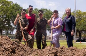 Brig. Gen. Julie L. Nethercot (left), Sgt. Maj. Robin C. Fortner (Ret.) (left center), Lt. Col. Axia R. Dones, 4th Recruit Training Battalion Commanding Officer (center), Col. Maria Marte (Ret.) (center right), and Rhonda Amtower, National President of the Women Marines Association, pose for a photo in front of the exposed time capsule on MCRD Parris Island SC, May 5, 2022. (U.S. Marine Corps photo by Lance Cpl. Michelle Brudnicki)